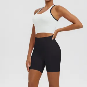 Detailed view of the women athletic yoga set featuring a white sports bra and black shorts.