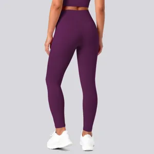 Detailed back view of high-waisted solid dark purple yoga pants showing smooth, elastic fit.