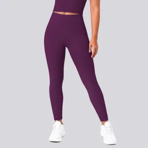 High-waisted plum purple yoga leggings detail showing elastic stretch fabric and hip lifting fit.