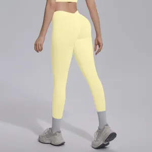 Seamless knit V-waist fitness yoga pants in light yellow, offering breathable push-up design.