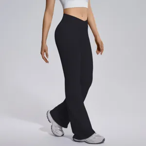 Detail view of black crossover waist flare yoga pants, highlighting slim fit and stretchy fabric.