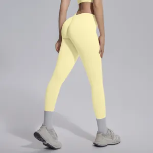 Yellow seamless knit V-waist butt-lifting tight yoga pants detail view for fitness running.