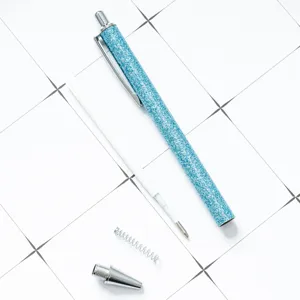 Blue glitter retractable ballpoint pen with replaceable refill and metal components.