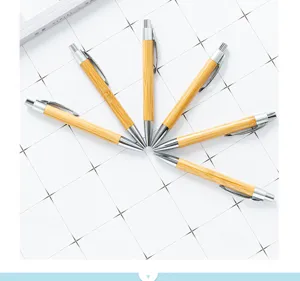 Natural bamboo ballpoint pen with metal clip, eco-friendly push-action office writing pen.