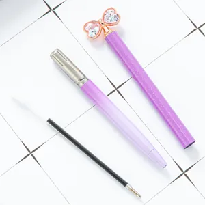 Cute bow ballpoint pen with sparkling diamond crystal design, smooth writing purple pen for gifts.