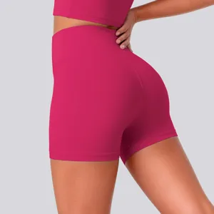 Detail view of high-waisted magenta yoga shorts, featuring stretchy breathable athletic fabric.