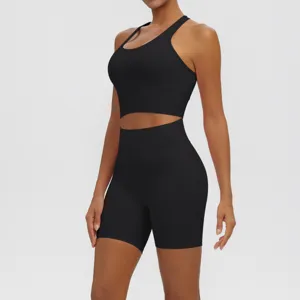 Detail view of black seamless athletic crop top and high-waisted shorts set for fitness yoga.