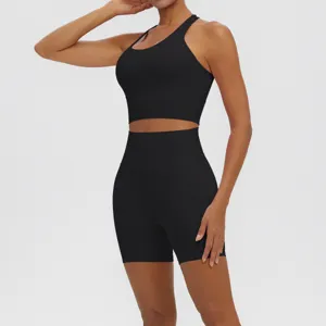 Detail view of the black seamless athletic yoga set featuring ribbed crop top and shorts.