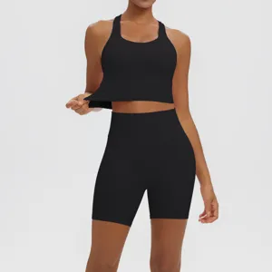 Black seamless yoga set with racerback sports bra and high waist biker shorts detail.