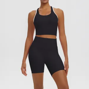 Detail shot of women activewear set featuring black sports bra with white trim and shorts.