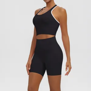Close-up detail of black athletic yoga crop top and high-waisted biker shorts set.