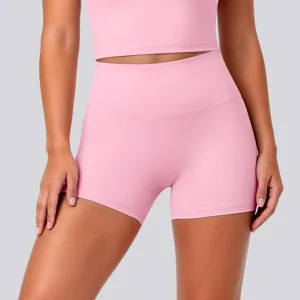 High-waisted pink yoga shorts close-up, stretchy seamless athletic fitness workout activewear.