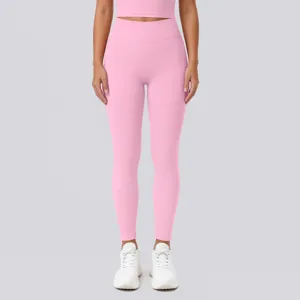 Pink high-waisted seamless yoga leggings and crop top detail view for fitness and running.