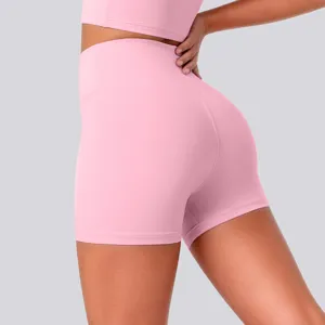 Close-up detail shot of pink high-waisted yoga shorts featuring stretchy breathable fabric.