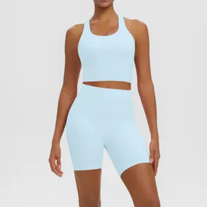 Detailed view of solid color backless athletic yoga crop top and biker shorts activewear set.