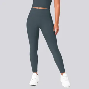 Detail view of high waisted dark grey yoga leggings and crop top showing fit and fabric texture.