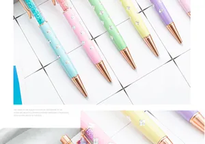 Colorful four-leaf clover crystal ballpoint pen with liquid glitter top and metal tip.