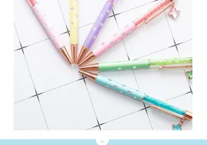 Colorful four-leaf clover crystal ballpoint pens with liquid glitter and hanging charms for gifts.