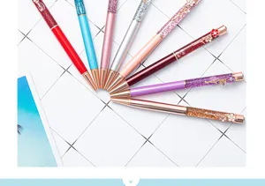 Colorful oil quicksand ballpoint pen with glitter sequins and flower charm for smooth writing.