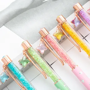 Colorful liquid glitter crystal ballpoint pens with four leaf clover charms for gift.