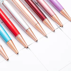 Colorful metal ballpoint pens set with rose gold tips, elegant office and school stationery