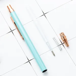 Retractable metal ballpoint pen with mint green barrel and rose gold trim, office school use.