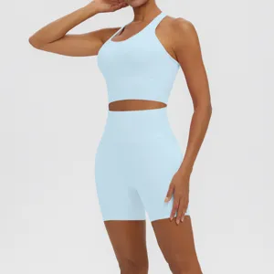 Close-up detail view of light blue athletic sports bra and high-waist yoga shorts set.