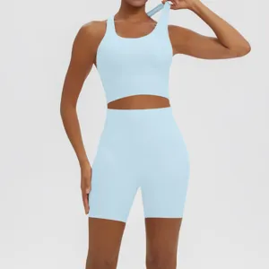 Light blue seamless yoga set, athletic tank top and high-waist shorts for gym fitness training.