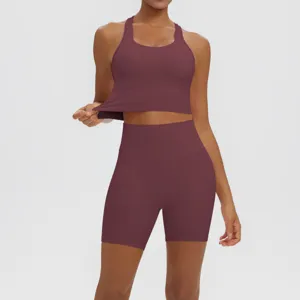 Burgundy fitness two-piece yoga set detail showing seamless texture and high-waisted fit.
