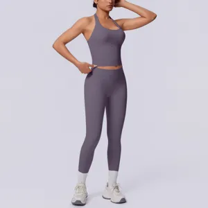 Dettaglio sportswear halter senza cuciture, crop top fitness e leggings sportivi vita alta.