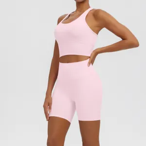 Pink workout activewear detail, breathable fitness yoga top and high waist shorts.