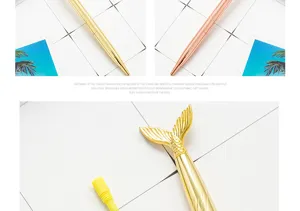 Detailed close-up of luxury metal ballpoint pen featuring unique mermaid tail design.