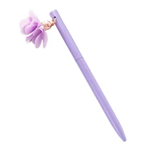 Purple metal ballpoint pen with cute fabric flower pendant charm for student and office stationery.
