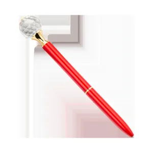 Detailed view of red metal ballpoint pen featuring a faceted crystal ball top and gold accents.