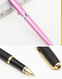 Detailed close-up of metal rollerball pen with golden and silver clips and fine tip.