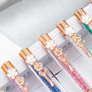 Crystal ballpoint pen featuring a rose gold metal body, clover pearl clip, and colorful glitter.