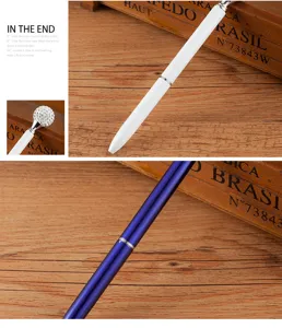 Detail view of the metal ballpoint pen featuring a sparkling diamond top and sleek finish.