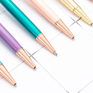 Ensemble de stylos a bille metalliques colores avec des pointes en or rose, papeterie elegante.