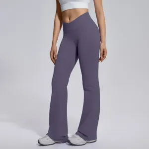 Detail view of women crossover high waist flare yoga pants, stretchy fitness workout leggings.