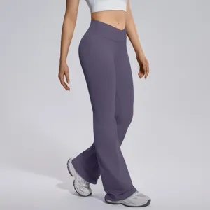 Detail view of women crossover high waist flare yoga pants, seamless stretch fitness activewear.