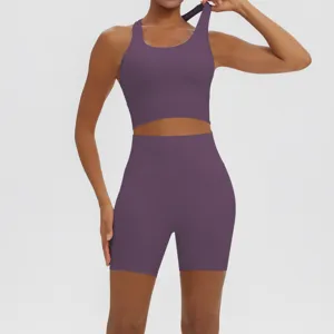 Solid purple two-piece yoga set featuring a breathable sports bra and high-waist biker shorts.