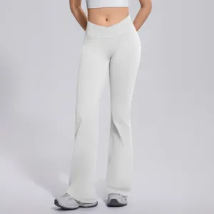 Crossover waist detail of women's white flare yoga pants, highlighting smooth elastic fit.