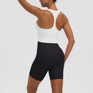 Back detail view of women's solid color racerback sports bra and black yoga shorts set.
