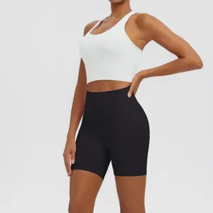 Close-up of white sports bra and black high-waist yoga shorts set for fitness running