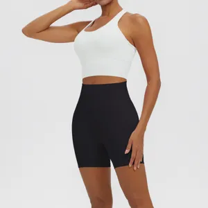 Women solid color sports yoga set featuring a white backless bra and black high waist shorts.