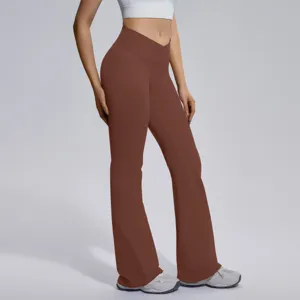 Detail view of women's brown crossover high waist micro flare yoga pants for fitness workout.