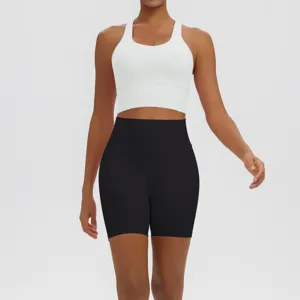 Detailed view of women white sports bra and black high waist yoga shorts activewear set workout.