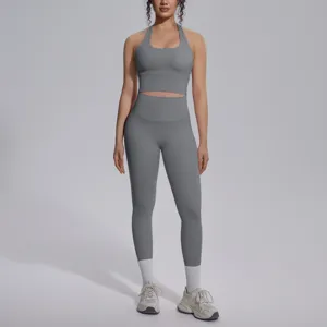 Gedetailleerd aanzicht van grijze yogaset met rugloze top en leggings, elastische stof.