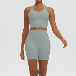 Solid color seamless racerback sports bra and high-waisted biker shorts activewear detail view.