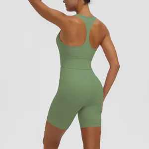 Solid green activewear yoga set featuring a racerback sports bra and high waist biker shorts.